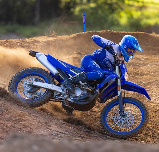 Action image of Yamaha WR250F 2024 in blue colourway, roosting berm