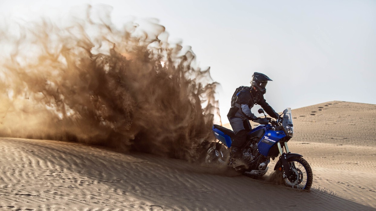 Action image of Yamaha Tenere 700 in Blue Colourway, rear wheelspin sand arc desert