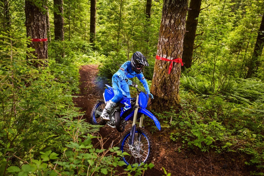 YZ125X 2025 static image of enduro bike racing around tree