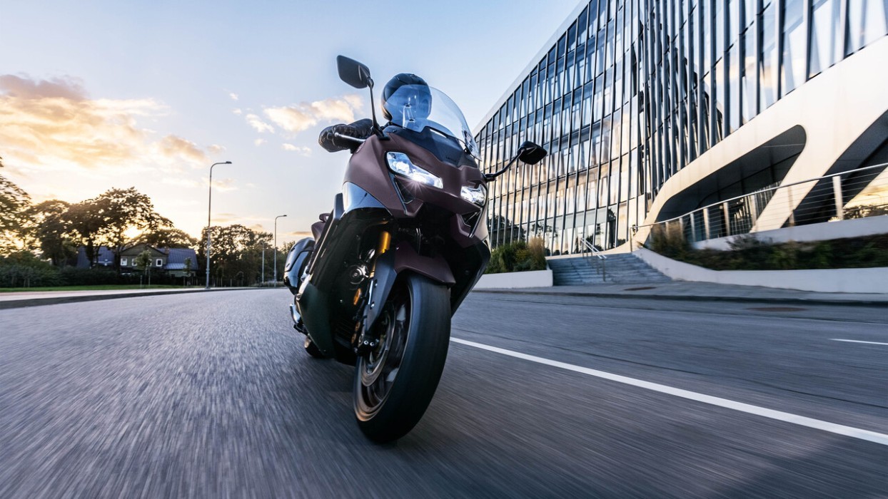 Action image of Yamaha TMAX 560, riding through city road