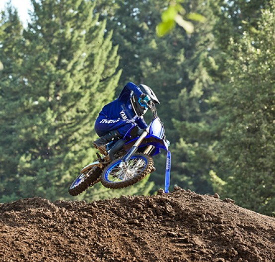 Action image of Yamaha YZ85 two stroke in Blue colourway, small jump