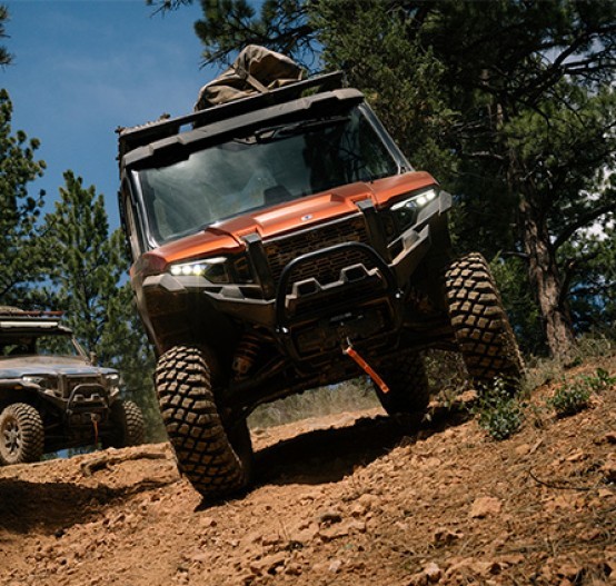 Outdoor actoin image of Polaris Xpedition ADV 5 Northstar driving over rocky road