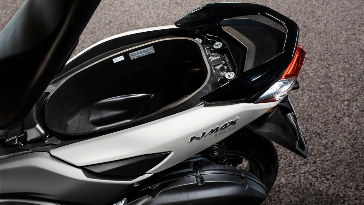 Detail image of Yamaha NMAX 155 scooter in white colourway, underseat storage compartment