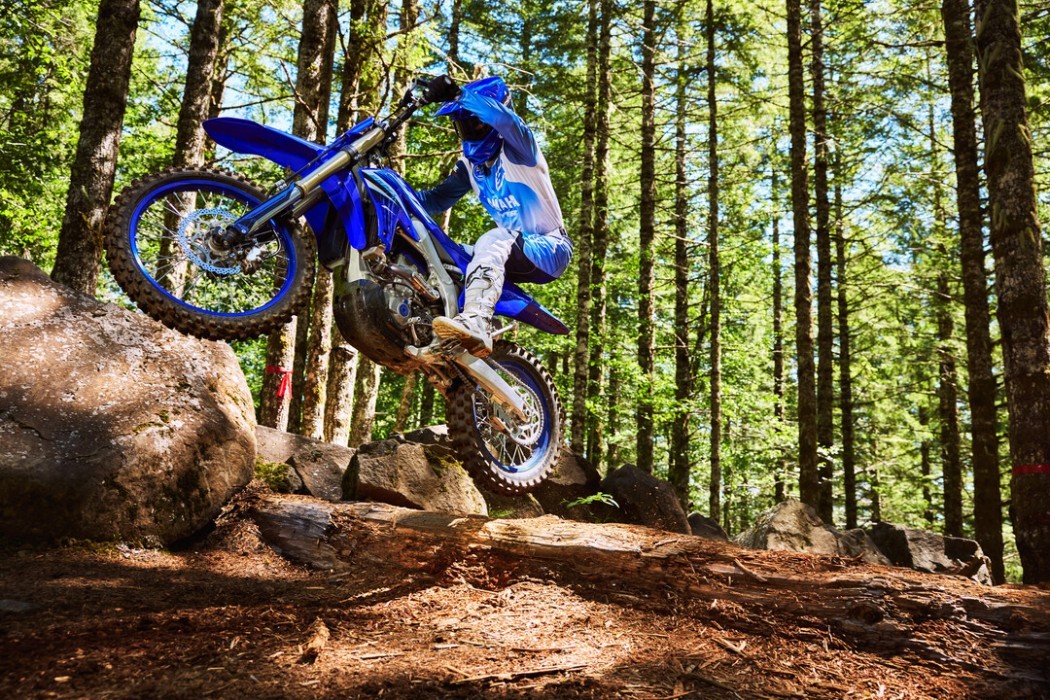 YZ250FX 2025 static image of enduro bike jumping over log