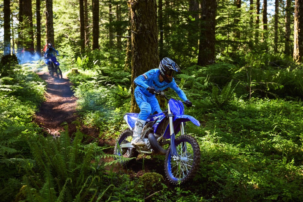 YZ250X 2025 static image of enduro bike racing through forest