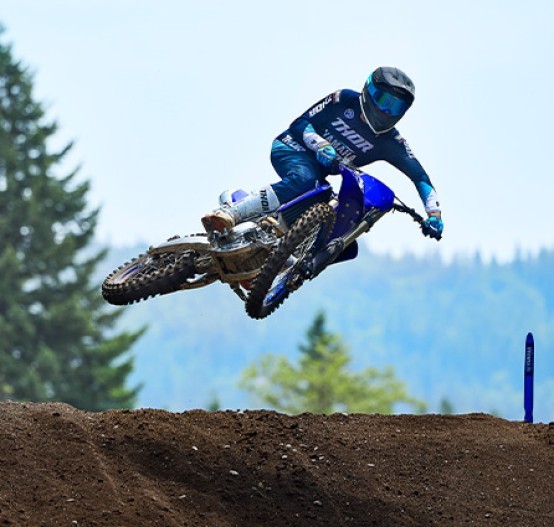 Action image of Yamaha YZ450F 2024 Motocrosser in Blue Colourway, small jump