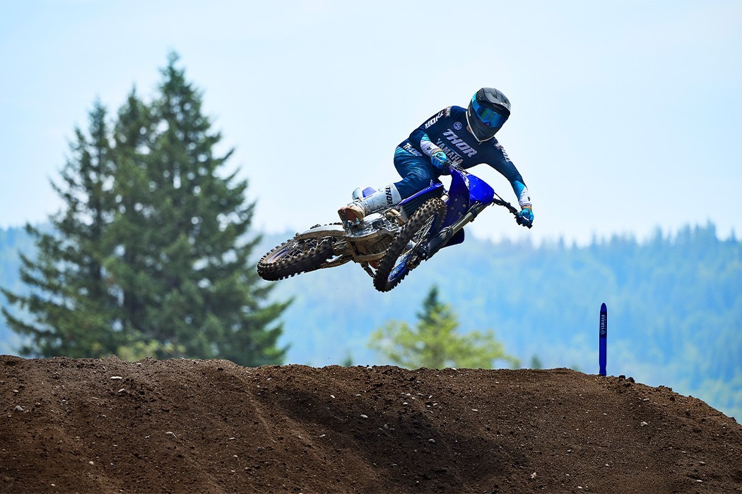 Action image of Yamaha YZ450F 2024 Motocrosser in Blue Colourway, going over a small jump