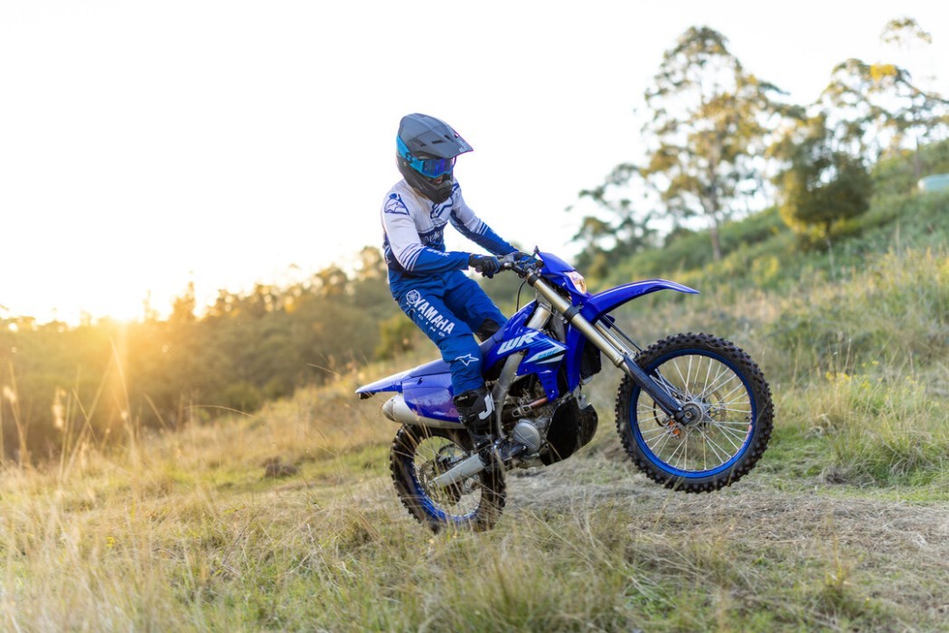 WR250F 2025 action image wheelie in paddock