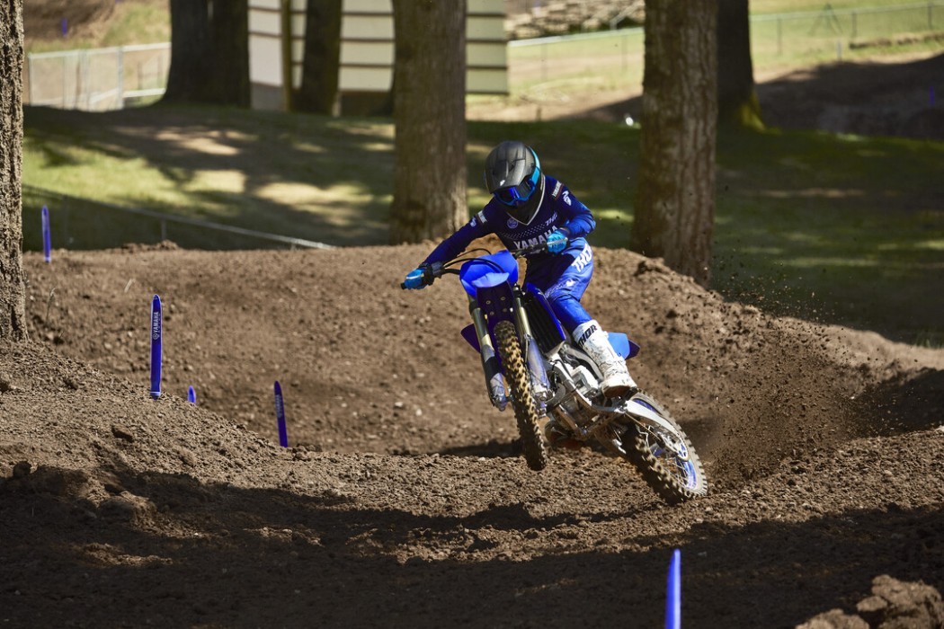 Action image of Yamaha YZ125 two stroke in Blue colourway, wheelie