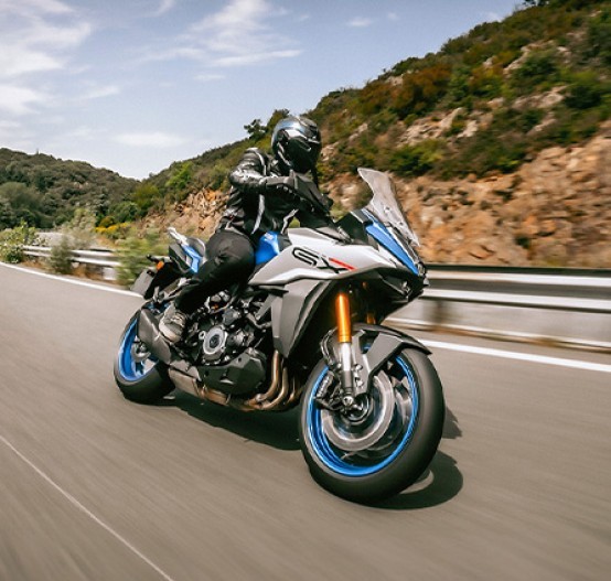 Action image of Suzuki GSX-S1000GX in blue colourway, sport riding on mountain road