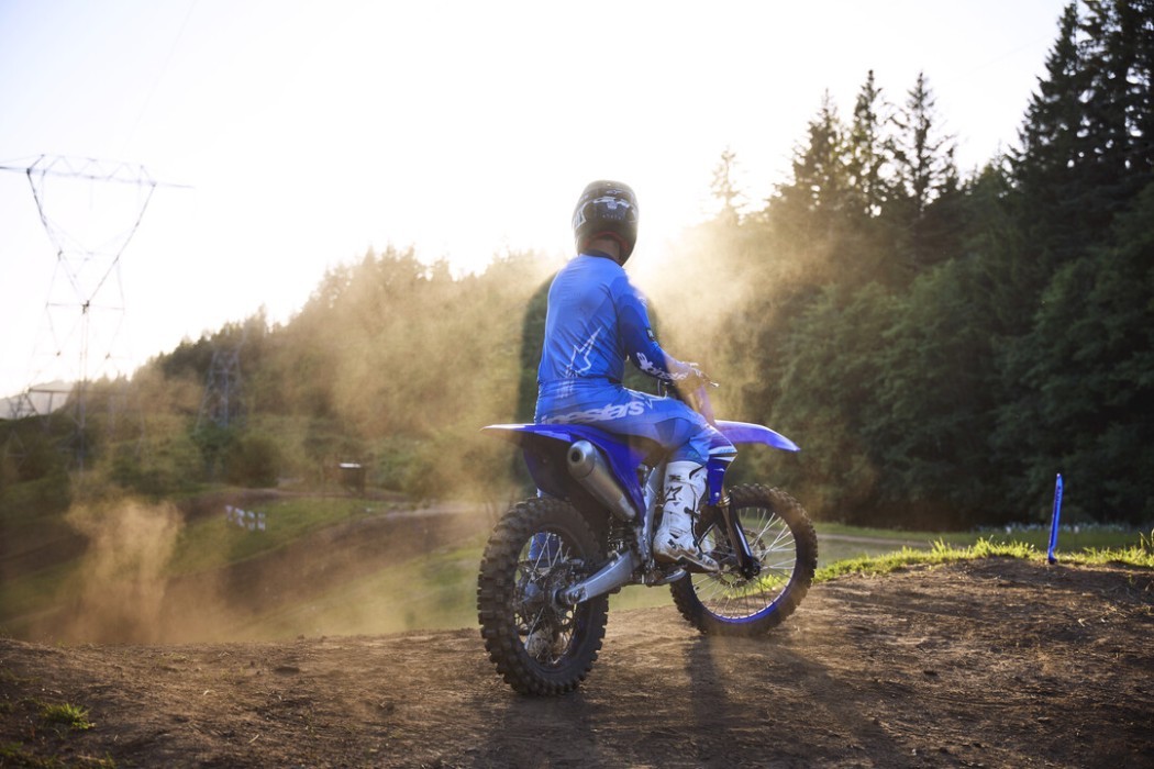 YZ450F 2025 static image of motocross bike with rider standing still on jump