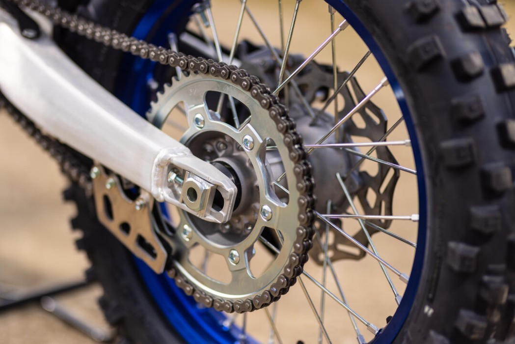 Detail image of Yamaha WR250F 2024 in blue colourway, Rear sprocket chain and wheel spokes