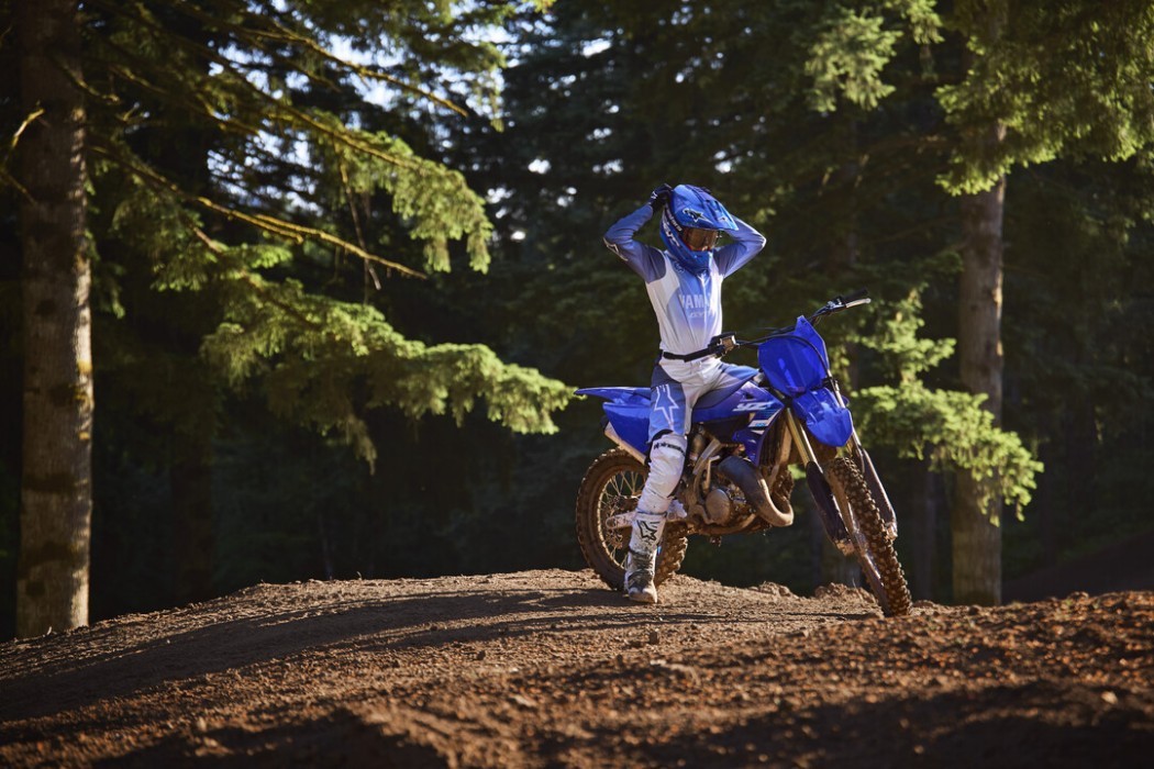 YZ125 2025 static image of motocross bike with rider sitting on jump