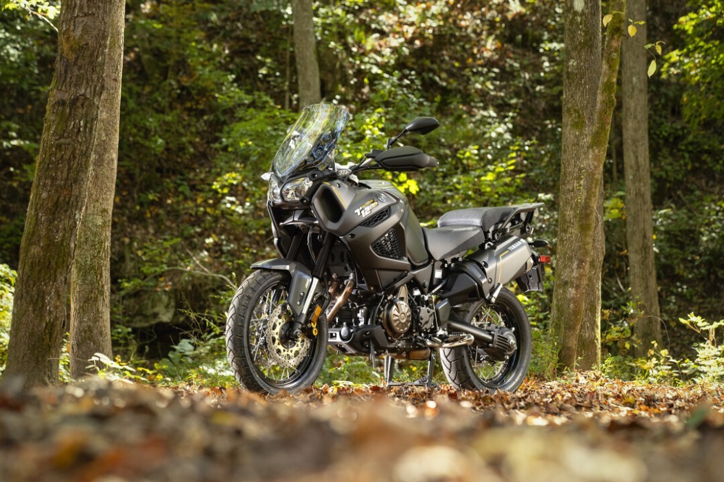 Static image of Yamaha Super Tenere in Black Colourway, oudoor forest landscape