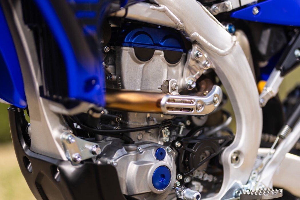 Detail image of Yamaha WR250F 2024 in blue colourway, engine and exhaust header close up
