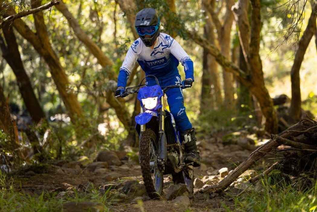 Yamaha WR450F 2025 in blue colourway, rider in action through bush section