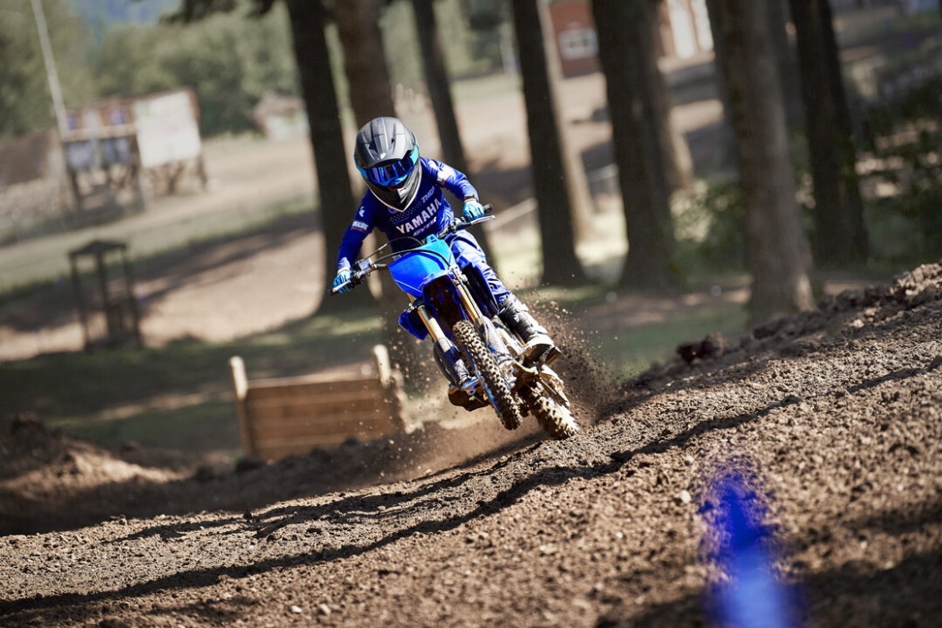 Action image of Yamaha YZ65 two stroke in Blue colourway, head on small wheelie