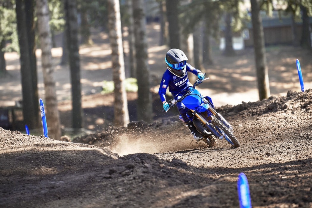 Action image of Yamaha YZ65 two stroke in Blue colourway, head on through corner
