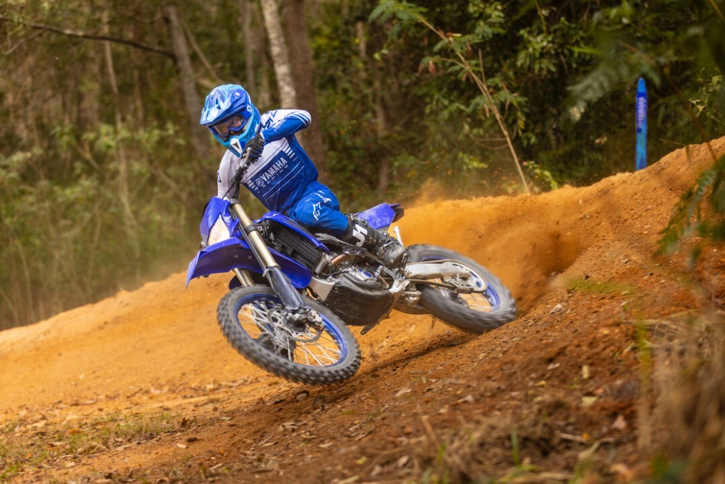 Action image of Yamaha WR250F 2024 in blue colourway, accelerating out of berm