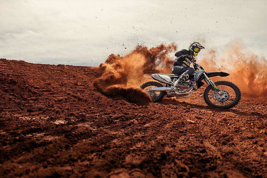 Action image of Triumph TF 250-X motocross bike roosting