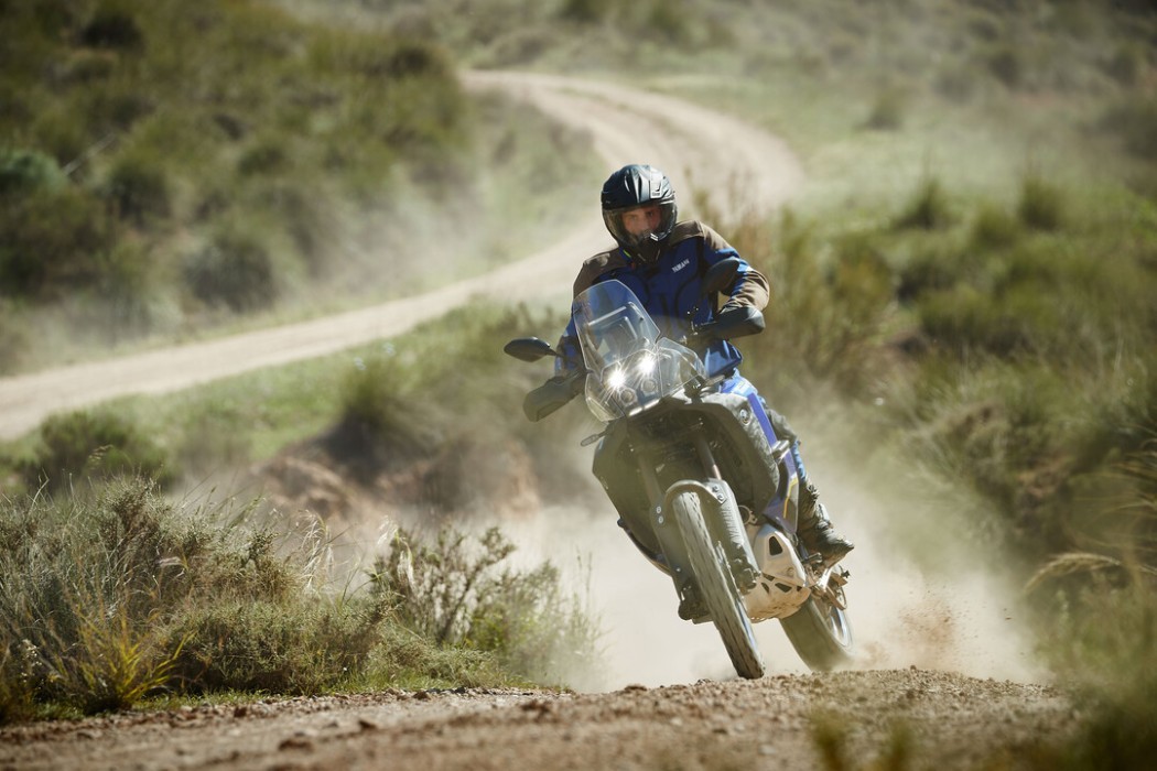 Action image of Yamaha Tenere 700 World Raid in Blue Colourway, accelerating over hill